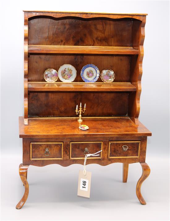 A miniature yewwood dresser and miniature items